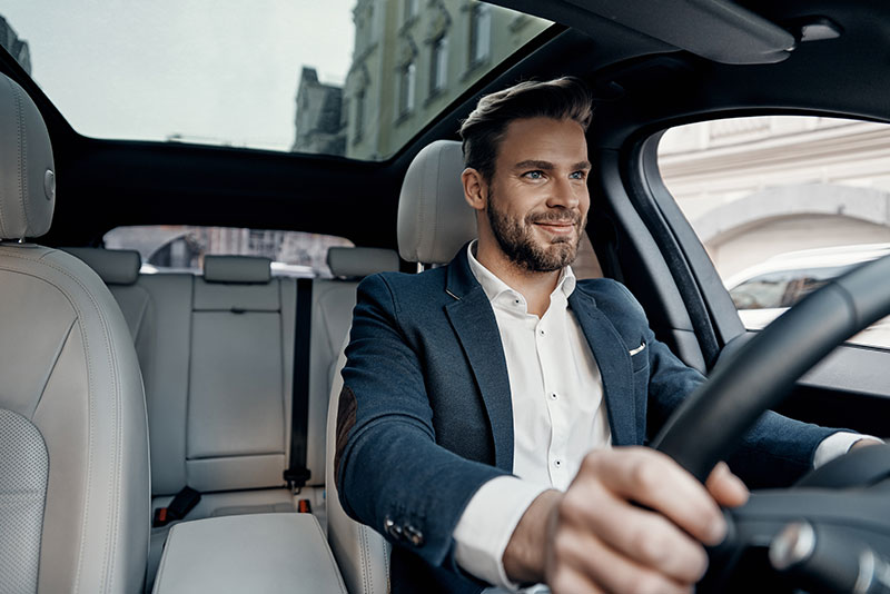 man driving his new car; DEXSTA auto loan