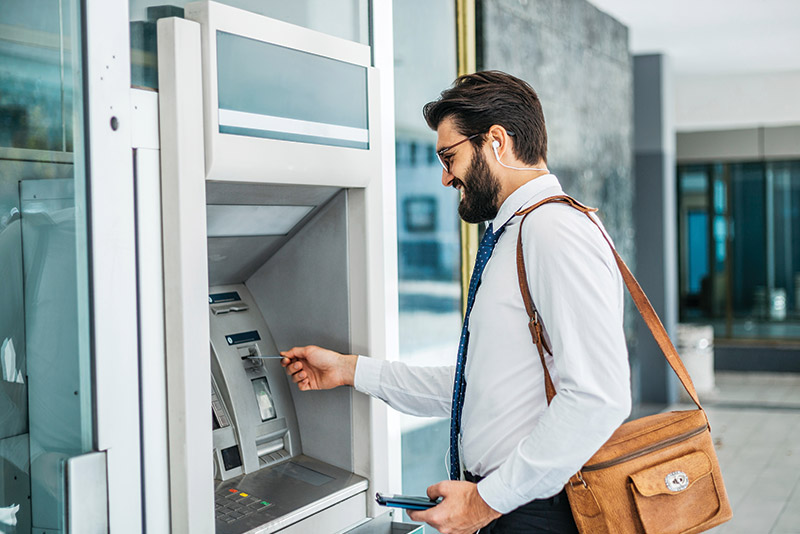 man at a credit union atm