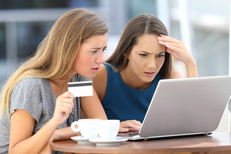 identity theft two girls looking concerned at computer