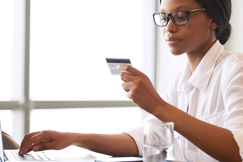 stolen identity woman looking at a credit card