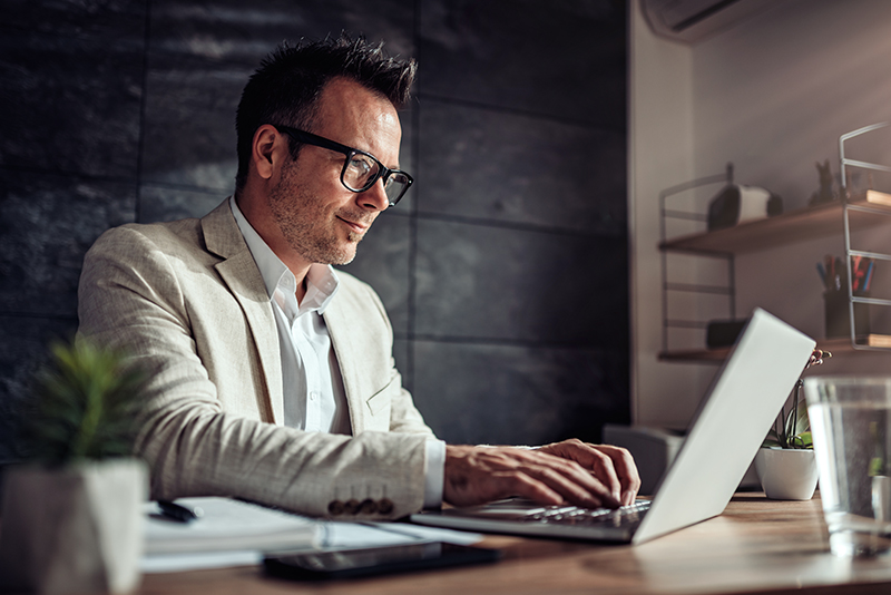 Man working on a laptop; how to prepare for a recession