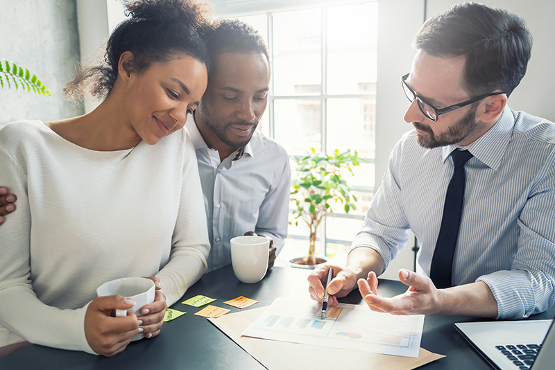 A man and woman review paperwork; federal credit unions