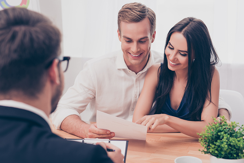 A couple making a down payment on a house