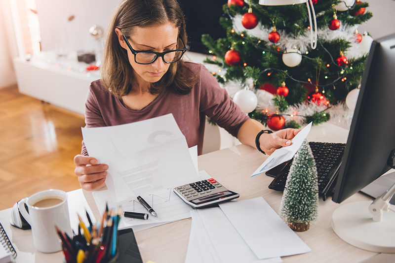 A woman working on holiday budgeting