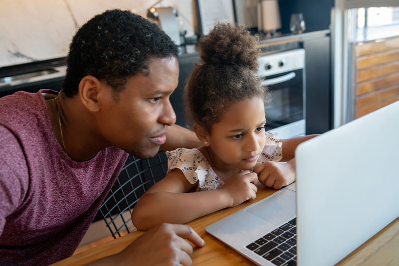 money making tips, dad with daughter at computer