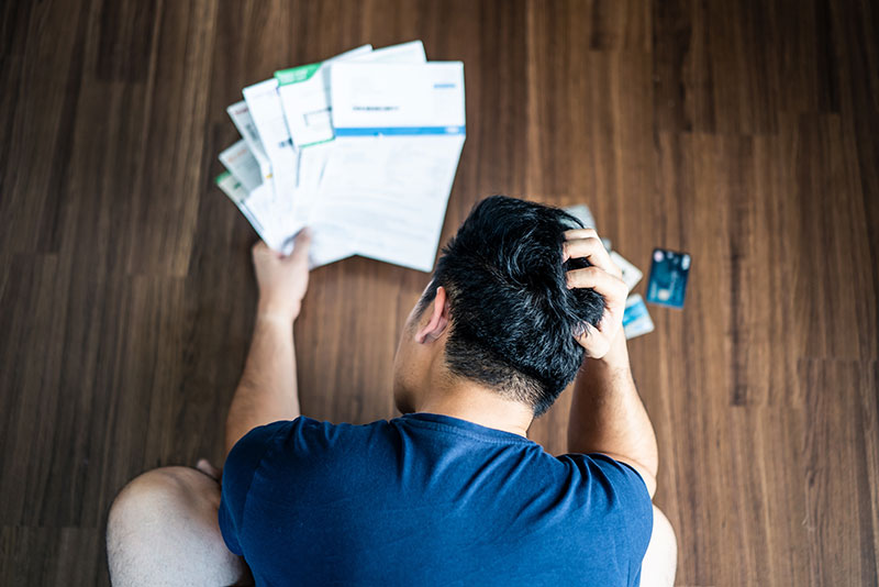 debt consolidation, man looking at financial papers