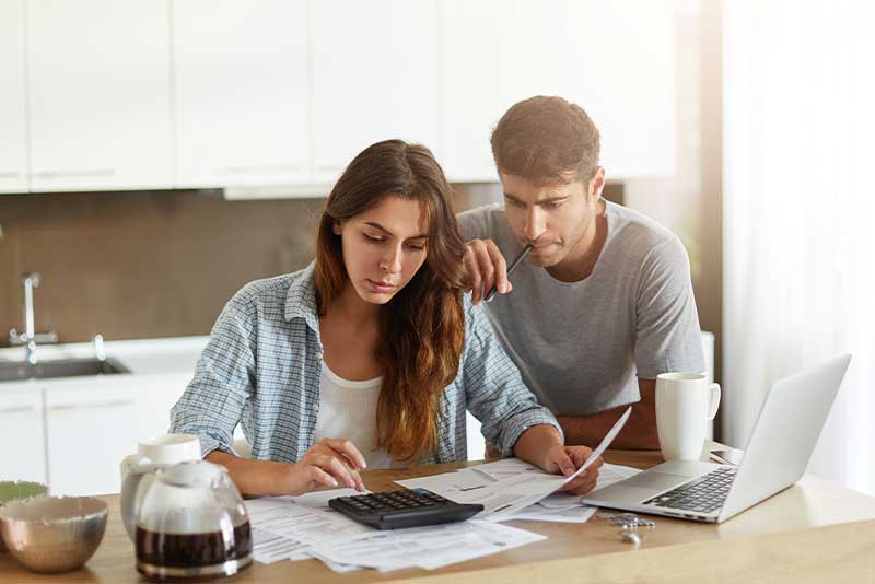 Man and woman work with DEXSTA to create a financial budget in order to reduce their financial stress.