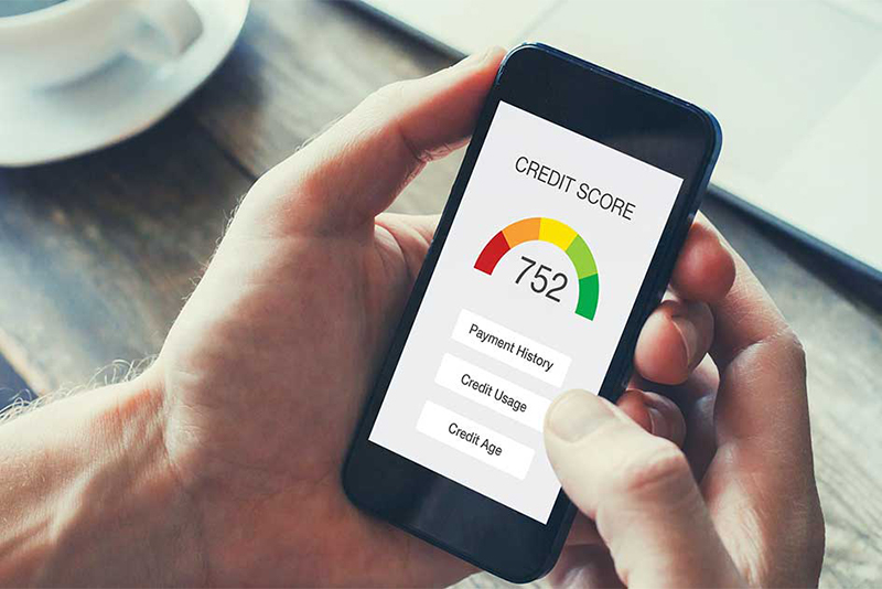 raise your credit score, man holding phone with score on it reading 752