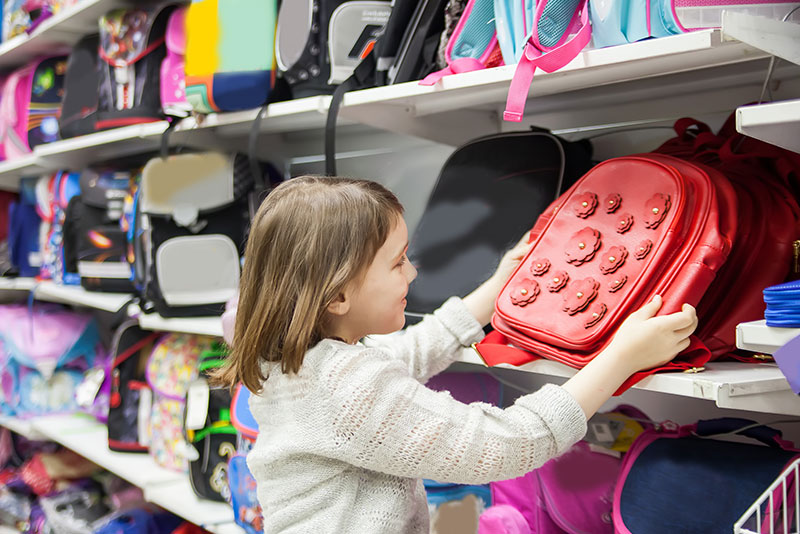 A young girl back-to-school shopping