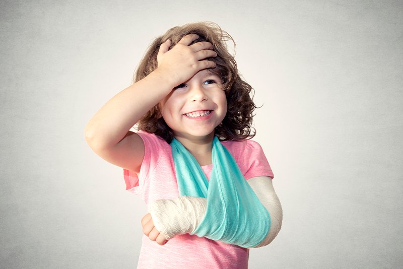 child smiling and laughing with an arm cast on - showing how a personal emergency loans can help you overcome everyday accidents without sacrificing your financial future