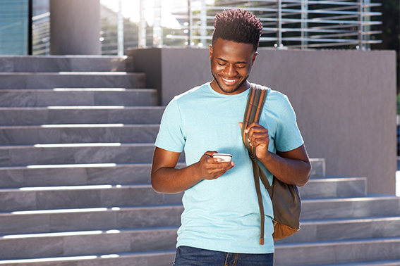 Teen looking at his phone to do Banzai's financial literacy class