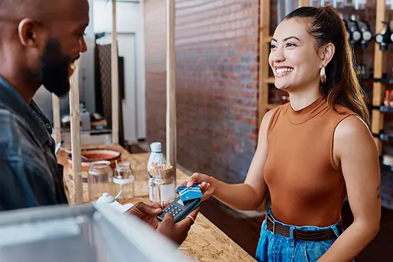 a woman getting rewards in her kasasa saver by making a purchase