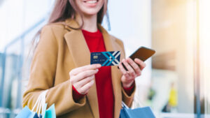 Woman holding a DEXSTA credit card