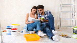 couple sitting on floor of room with paint cans for a blog about alternative mortgage options